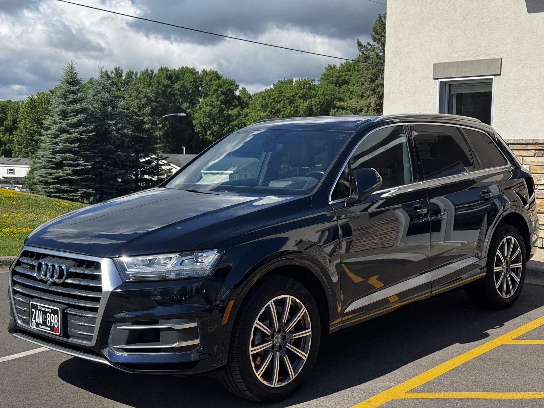 Dark blue Audi Q7 outside the QMD studio